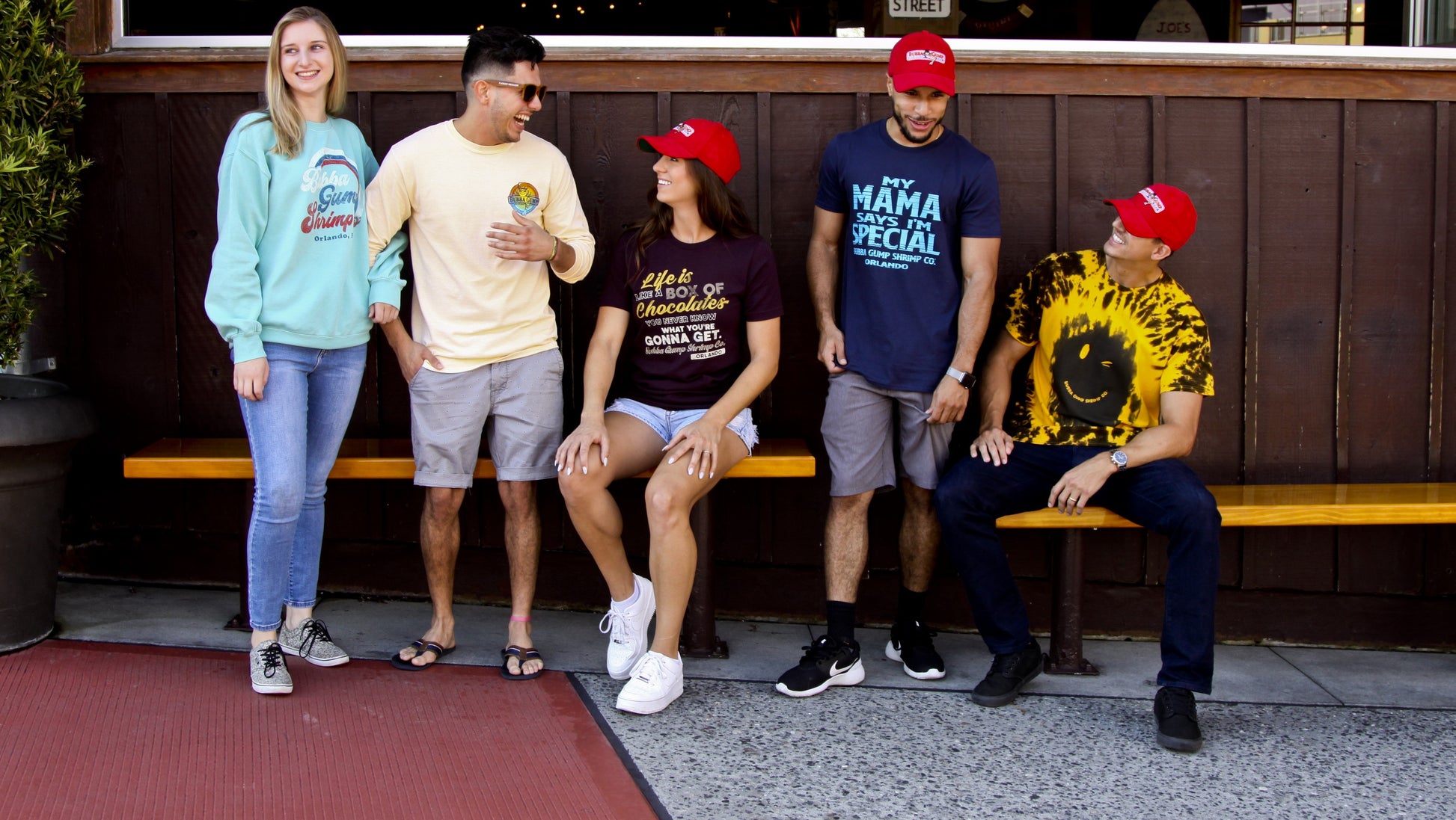 Group of 5 friends sitting on a bench with 3 of the friends wearing the Authentic Forrest Gump cap.